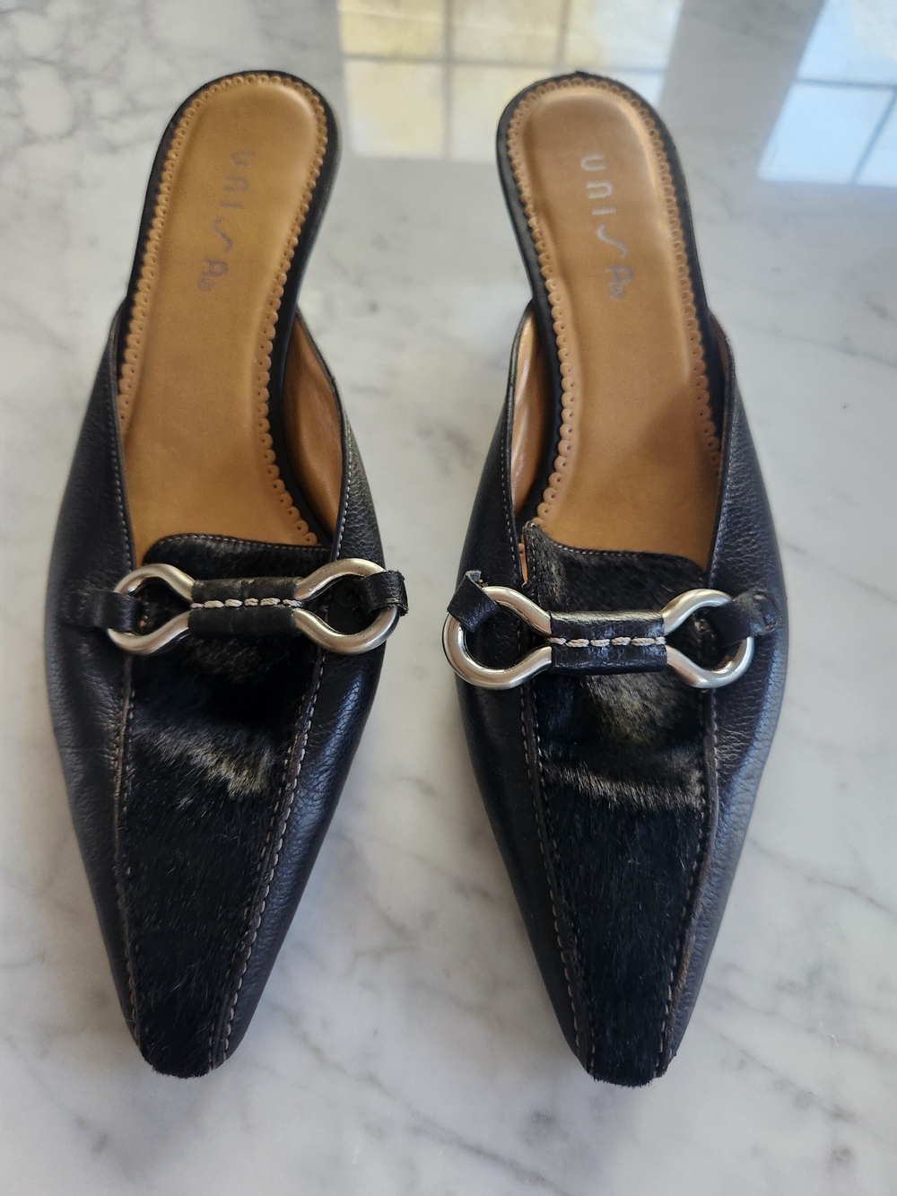 Unisa Black Leather Mule with Silver Hardware and cow hide on top.